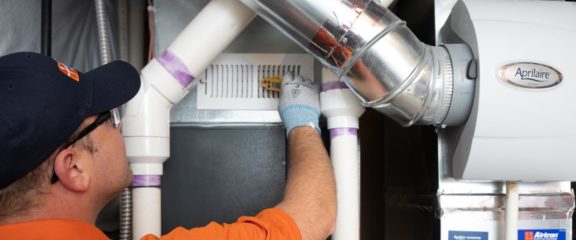 photo of an Airtron technician repairing a duct system