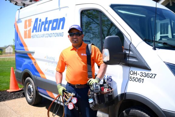 Airtron HVAC service van and technician ready for heating repair