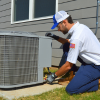 Airtron technician with new air conditioner